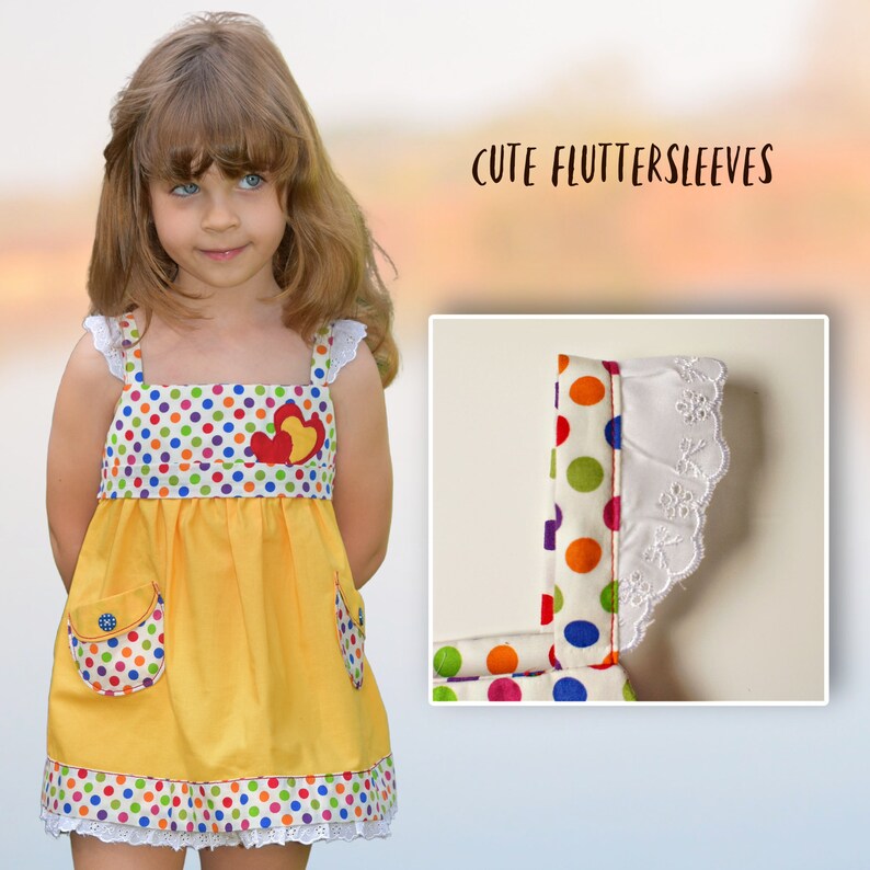 Natalie girls pinafore dress, pdf sewing pattern by Frocks & Frolics. High waist and sash with ties.  Here featuring a polka dot bodice and uni skirt in yello with lace detail. Double layer hem completes the look.