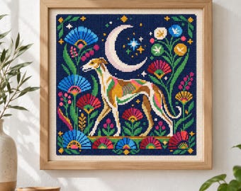 May include: A square cross-stitch embroidery in a light wood frame featuring a stylized dog standing in a garden of colorful flowers under a crescent moon and stars against a dark blue background. The dog has tan, white, and pink markings.