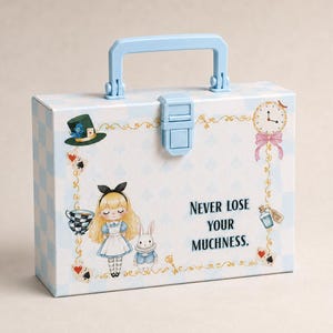 May include: A light blue and white checkered rectangular carrying case with a top handle and latch. The front features illustrations of a blonde character, a white rabbit, a top hat, a clock, and the text "NEVER LOSE YOUR MUCHNESS."
