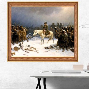 以下が含まれることがあります： 雪景色の中の歴史的な軍事シーンを描いた額装された油絵。中央の人物が白い馬に乗り、ライフルを持った暗い制服の兵士たちに囲まれている。雪の上には倒れた人物が横たわり、大砲が見える。