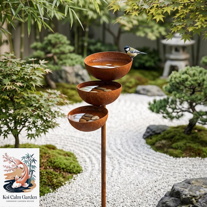 May include: A tiered bird bath featuring three rusted metal bowls stacked vertically on a central pole. Each bowl contains water and smooth river stones. A small bird with yellow and black markings perches on the rim of the top bowl.