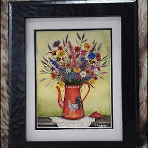 May include: A framed painting of a vibrant wildflower bouquet in a red teapot with a rooster illustration. The teapot sits on a white lace doily on a wooden surface against a light green background. The artist signature L. Buckman is visible.