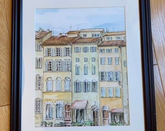 Puede incluir: Una pintura de acuarela de una fila de edificios amarillos con marcos de ventanas y contraventanas marrones. Los edificios tienen un encanto rústico y están pintados en un estilo realista.