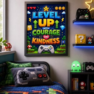 May include: A framed wall poster with a dark blue background featuring pixelated graphics and the text "LEVEL UP WITH COURAGE AND KINDNESS". The design includes a yellow star, red hearts, gold coins, a blue diamond, and a white game controller.