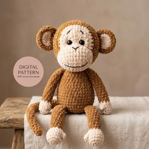 May include: A brown and cream crocheted monkey toy with black plastic eyes and a stitched mouth. A circular pink graphic on the left side contains the text DIGITAL PATTERN (PDF Instant Download). The monkey has large ears and a long tail.