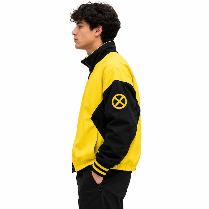 Side profile of men's yellow and black bomber jacket with X patch on sleeve and yellow striped ribbed cuff