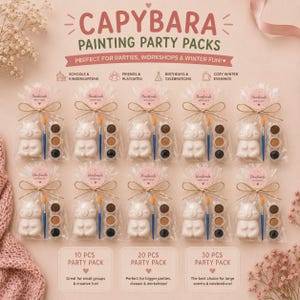 May include: Ten clear plastic bags containing a white capybara figurine, a blue paintbrush, and a three-color paint palette. Each bag is tied with twine and a round sticker labeled Handmade with Love. Text includes CAPYBARA PAINTING PARTY PACKS.
