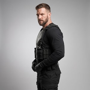 May include: A black tactical vest featuring a white skull emblem on the chest, worn over a long-sleeved black shirt. The vest includes multiple integrated utility pouches and straps, paired with black tactical trousers and matching black gloves.