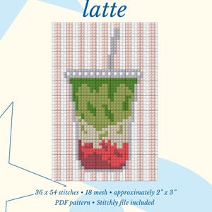 May include: A needlepoint stitch guide for a strawberry matcha latte pattern. The design features a pixelated drink in a cup with green and red layers, a straw, and a striped background. Text includes 36 x 54 stitches, 18 mesh, and 2 inches x 3 inches.