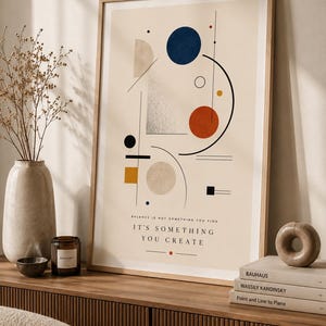 Puede incluir: Una lámina de arte mural vertical enmarcada con formas geométricas abstractas que incluyen círculos, cuadrados y líneas en azul, naranja, amarillo y beige. El texto dice: BALANCE IS NOT SOMETHING YOU FIND IT'S SOMETHING YOU CREATE en negro.