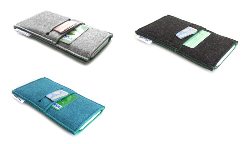 May include: Three felt phone cases with green stitching. The cases are gray, black, and teal. Each case has a card slot and a clear plastic window for displaying ID.