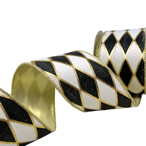May include: A roll of decorative ribbon featuring a repeating harlequin diamond pattern in black and white. The edges of the ribbon are finished with a metallic gold trim, and the diamond shapes are outlined with thin, shimmering gold lines.