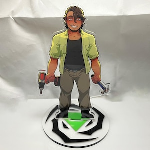 May include: A cartoon-style acrylic figure of a person holding a drill and a hammer. The figure is wearing a yellow button-down shirt over a black shirt, brown pants, and black boots. The figure stands on a white and black circular base with a green arrow.