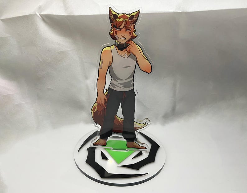 May include: A clear acrylic standee featuring a cartoon character with fox-like features. The character is wearing a white tank top, black pants, and a black choker. The standee is on a round base with a black and green design.