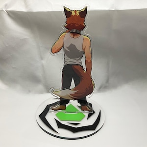 May include: A clear acrylic figure of a fox-like character, viewed from the back. The character wears a gray tank top, dark pants, and has a brown and white tail. The figure stands on a round base with a black and white design and a green accent.
