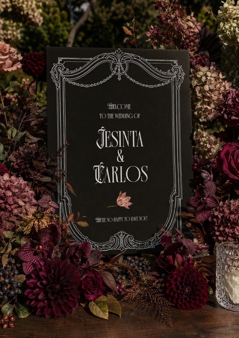May include: A rectangular black wedding sign with white decorative border detailing and text reading Welcome to the wedding of Jesinta & Carlos, with a small floral illustration and the text We're so happy to have you printed below.