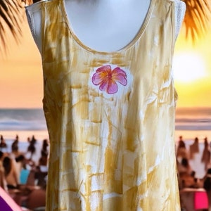 Light cotton tunic in neutral sand color with a plumeria.  Comes in tank or short sleeves.