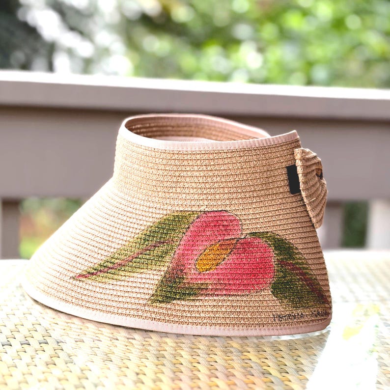 Earthy Obake anthurium in a muted light red and avocado green on this roll up visor