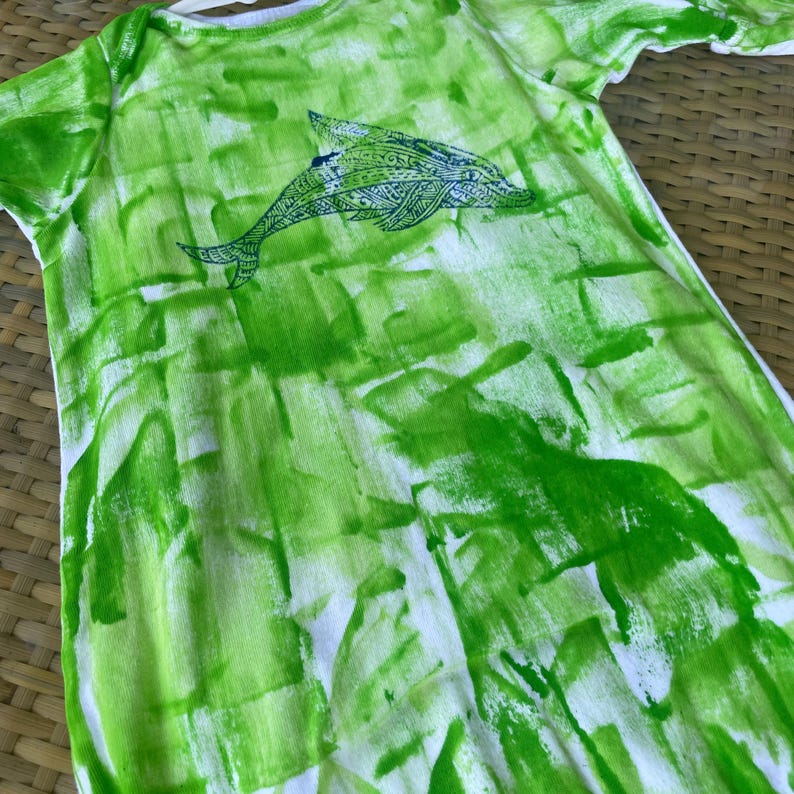 green sleep sack with dolphin motif