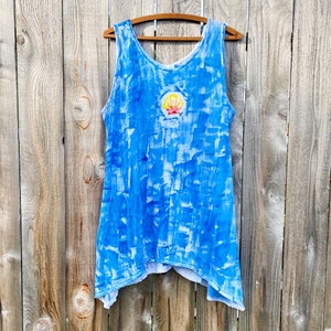 Sunrise shell on bright blue cotton tunic.