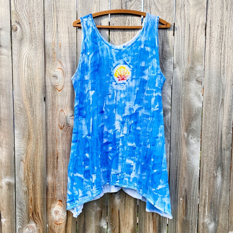 Sunrise shell on bright blue cotton tunic.