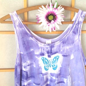 A periwinkle hand painted tank top with a teal butterfly hand block design.