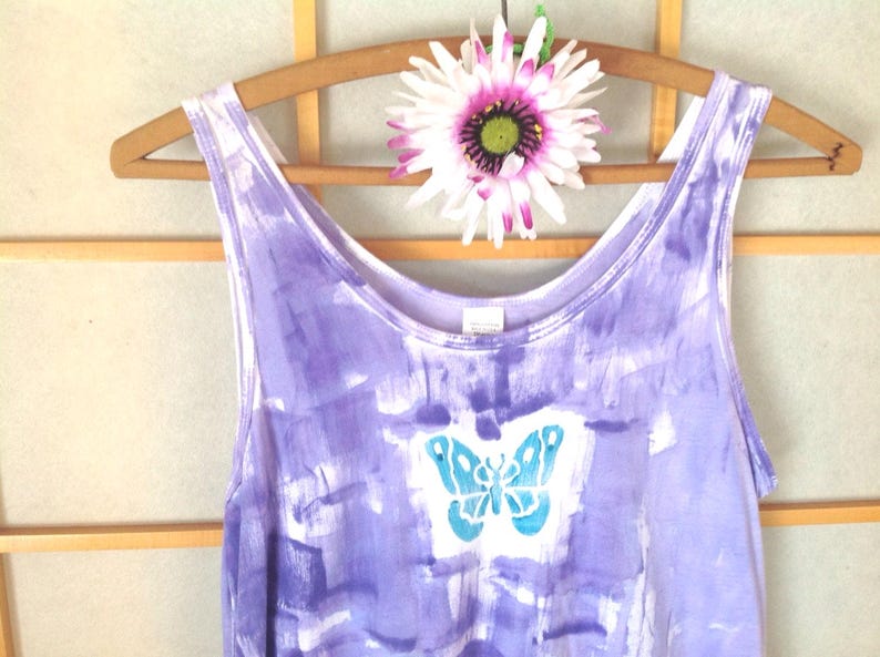 A periwinkle hand painted tank top with a teal butterfly hand block design.