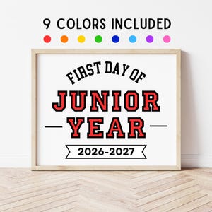 May include: A framed sign with the text 9 COLORS INCLUDED above eight colored circles. The main text reads FIRST DAY OF JUNIOR YEAR 2026-2027 in black and red block lettering. The sign is displayed in a light wood frame on a white background.