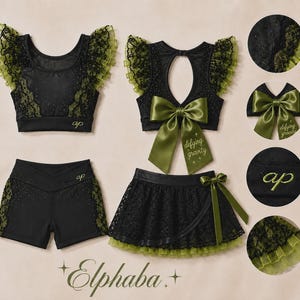 May include: A black and olive green athletic set featuring a crop top with ruffled lace sleeves, matching shorts, and a skirt. The top has a back cutout with a large olive bow embroidered with the text defying gravity. The text Elphaba is below.