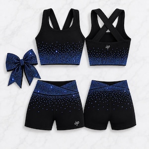 May include: A black athletic set featuring a crop top and shorts with a blue rhinestone gradient pattern. The top has a racerback design, and the shorts feature a high-waisted crossover waistband. A matching hair bow with blue rhinestones is included.