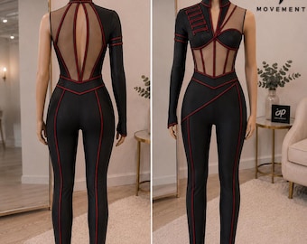 May include: A black jumpsuit with red piping, featuring a high collar, one long sleeve, and sheer mesh panels on the bodice and back. The front displays a red rectangular patch with the text AP MOVEMENT. The design includes a cutout back.