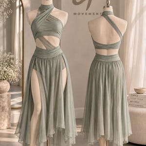 May include: A sage green two-piece dance costume featuring a halter-neck top with crisscross fabric straps and a cutout midriff. The matching skirt has a high-waisted band and a sheer, layered, asymmetrical hemline that falls below the knees.