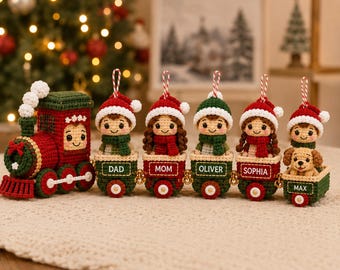 May include: A crocheted Christmas train ornament set featuring a red engine and five connected green train cars. Each car carries a crocheted figure wearing a Santa hat and scarf, with the names DAD, MOM, OLIVER, SOPHIA, and MAX embroidered on them.