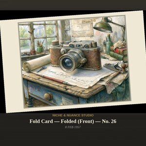 May include: A folded card featuring an illustration of a vintage camera resting on a desk with a rolled blueprint, a drafting pen, a small hand plane, books, and a desk lamp. The text NICHE & NUANCE STUDIO, Fold Card — Folded (Front) — No. 26, 8 FEB 1957 appears below.