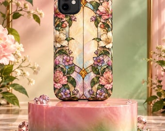 May include: A smartphone case featuring a stained glass design with pink, white, and purple flowers, green leaves, and a central light-colored panel. The case has a black camera cutout and is displayed on a cylindrical pink and green base.