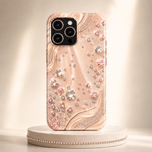 May include: A rose gold smartphone case featuring a swirling, liquid-like texture and an array of embedded clear and pink crystals. The case includes a prominent camera cutout with three circular lenses and a flash, with crystal accents.