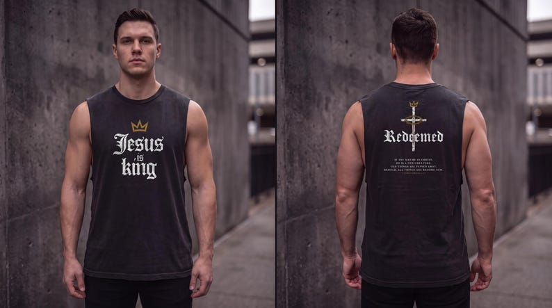 May include: A charcoal grey sleeveless muscle tank top featuring a gold crown icon and the white text Jesus is King on the front. The back displays a cross graphic with a crown, the word Redeemed, and additional small white text.