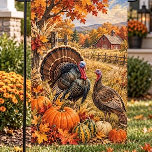 May include: A rectangular garden flag featuring a vibrant autumn scene with two turkeys standing among orange pumpkins and striped gourds. The background displays a red barn, golden trees, and a clear sky, all suspended on a black metal stand.