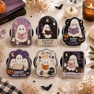May include: Six acrylic phone grips featuring ghost illustrations. Designs include ghosts reading books in a library, a ghost book club, and ghosts with text reading Haunted Library, Spooky Little Reader, Ghost Book Club, One More Boo-K, and Bookish Ghost.