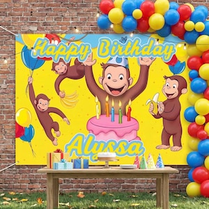 May include: A rectangular birthday banner featuring a yellow background with brown monkeys, a pink cake with lit candles, and the text Happy Birthday Alyssa. The banner is surrounded by a balloon arch in blue, yellow, and red, with gift boxes on a table.