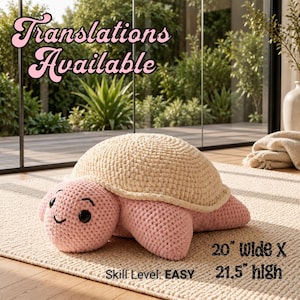 May include: A crochet turtle plush with a light pink head and limbs, and a cream-colored shell. The turtle has black plastic eyes and a stitched smile. Text reads: Translations Available, 20" Wide X 21.5" high, Skill Level: EASY.
