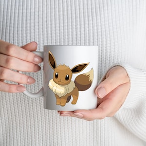 May include: A white ceramic mug featuring a graphic illustration of the brown and cream-colored Eevee character. The creature has large pointed ears, dark brown eyes, and a fluffy cream-colored collar around its neck with a bushy tail.