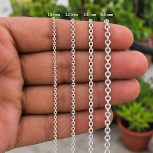 May include: Four silver-toned metal cable chains of varying thicknesses, labelled 1.5 mm, 2.0 mm, 2.5 mm, and 3.0 mm. Each chain consists of uniform, circular interlocking links arranged vertically, showcasing the size progression from thin to thick.