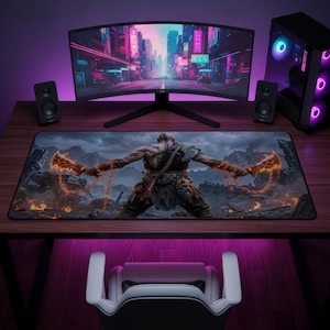 May include: A rectangular desk mat featuring a detailed graphic of a muscular warrior figure from behind, holding two glowing orange flaming blades attached to chains, set against a dark, rocky, and mountainous landscape with embers.
