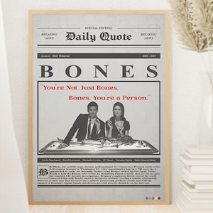 May include: A framed poster designed like a newspaper front page titled Daily Quote, featuring the television show Bones. It displays a black and white photo of two people behind a table with skeletal remains, with the red text: You're Not Just Bones, Bones, You're a Person.