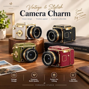 May include: Four digital cameras in white, black, olive green, and maroon, each featuring gold-tone accents, a prominent lens, and the text Digital Camera printed on the top. The cameras are arranged on a wooden surface with various props.