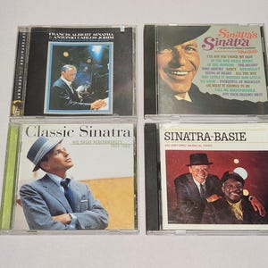 May include: Four compact discs featuring Frank Sinatra. The CDs showcase album covers with images of Sinatra, including portraits and performance shots. Titles include "Sinatra's Sinatra" and "Classic Sinatra."