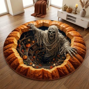 May include: A round area rug featuring a 3D optical illusion of a hollowed-out orange pumpkin. Inside the pumpkin, a skeletal figure draped in tattered beige fabric emerges from a dark, spiraling staircase decorated with small pumpkins and lanterns.