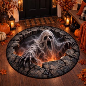 May include: A round rug featuring a 3D-style graphic of a pale, ghostly figure with a wide-open mouth and long fingers emerging from a dark, cracked stone pit. The design includes glowing orange light emanating from the depths of the hole.