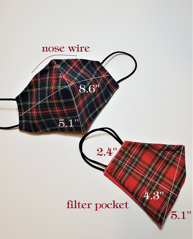 May include: Two plaid face masks with nose wires and filter pockets. The larger mask is black, red, and yellow plaid and measures 8.6 inches by 5.1 inches. The smaller mask is red, black, and yellow plaid and measures 4.3 inches by 5.1 inches.